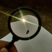 Magnifying glass concentrating the sun's rays onto a sheet of paper